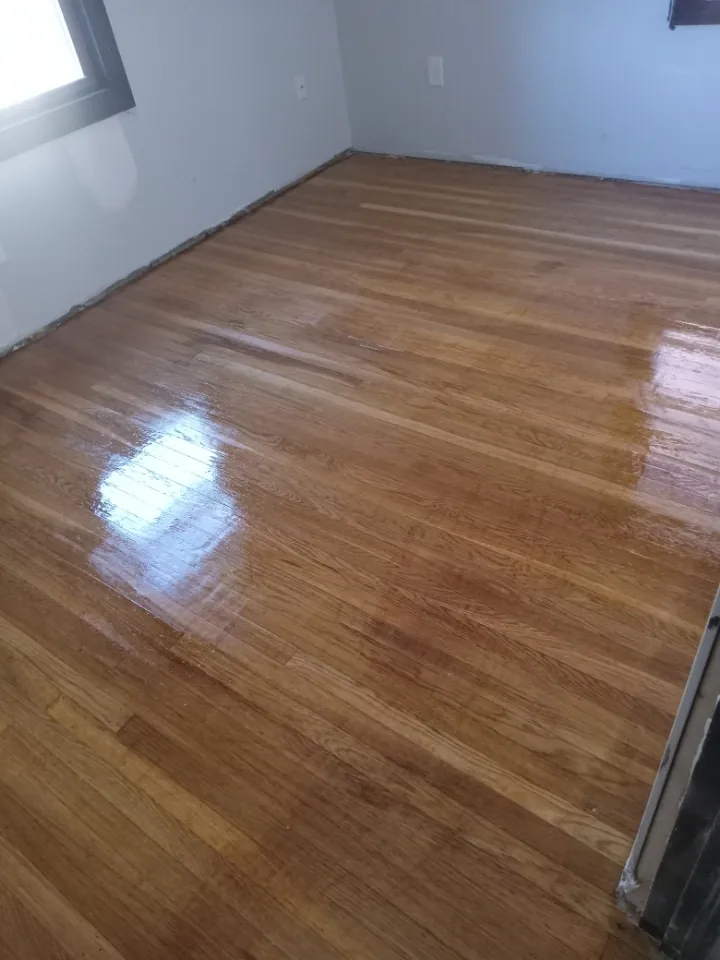Refinished hardwood floor in an empty room